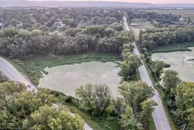 Drone image showcasing roads, lake, and forest in rural Wabasha, MN, during summer.