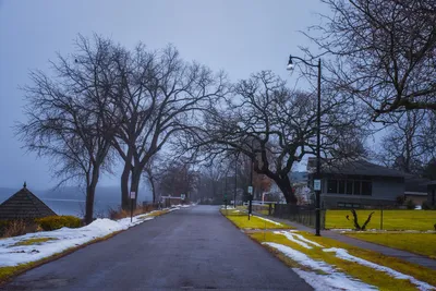 Quiet winter street scene with bare trees and snow, Wabasha, MN.